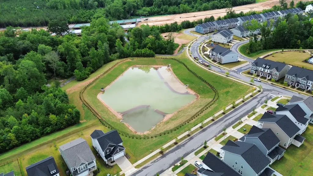 Aerial view of a completed stormwater pond system by Delcid in North Carolina