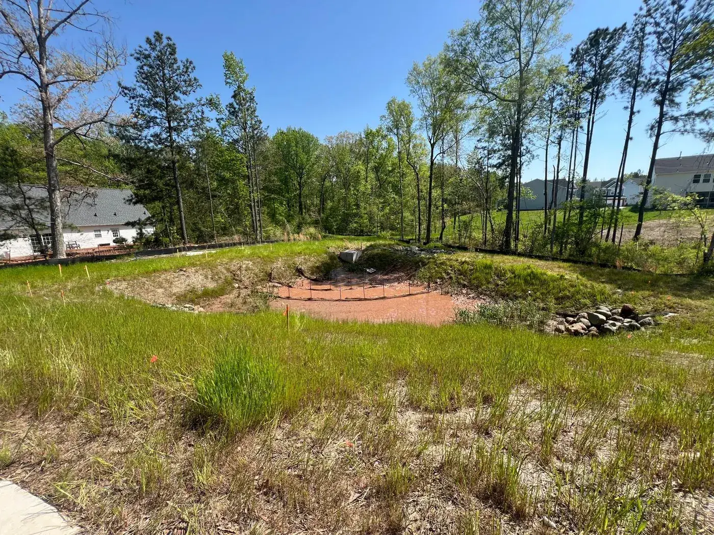 Bare, disturbed basin grade before stabilization work began