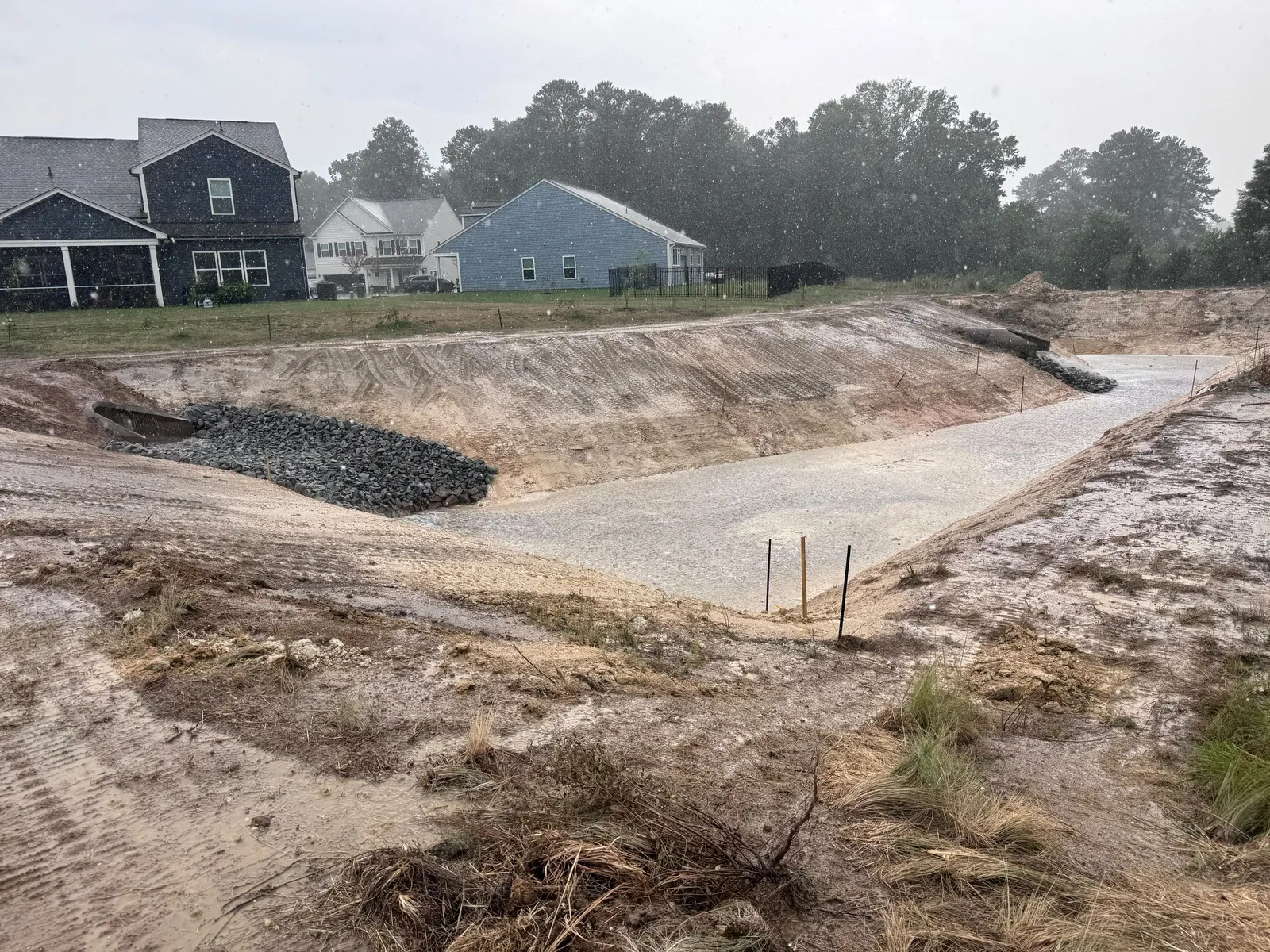 Graded stormwater basin with rip-rap outlet at Nathans Ridge Pond