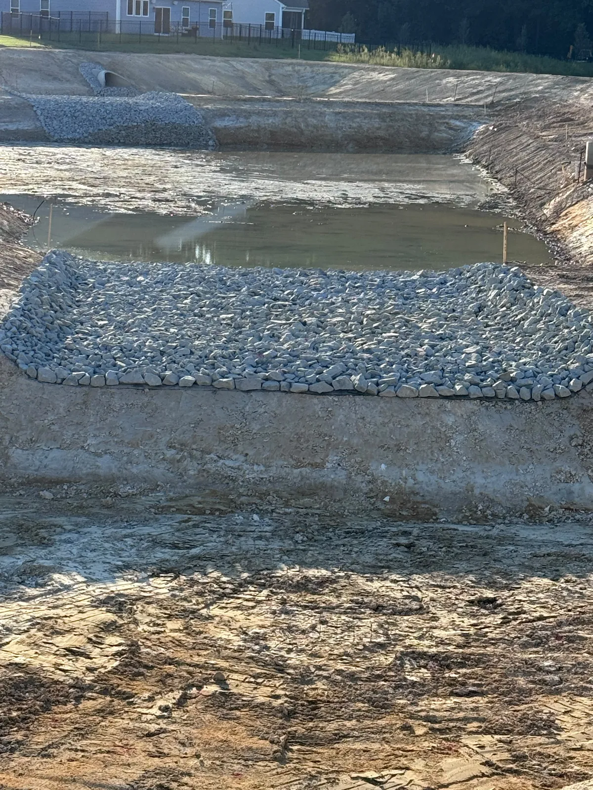 Rip-rap apron inside the graded basin at Nathans Ridge Pond 2