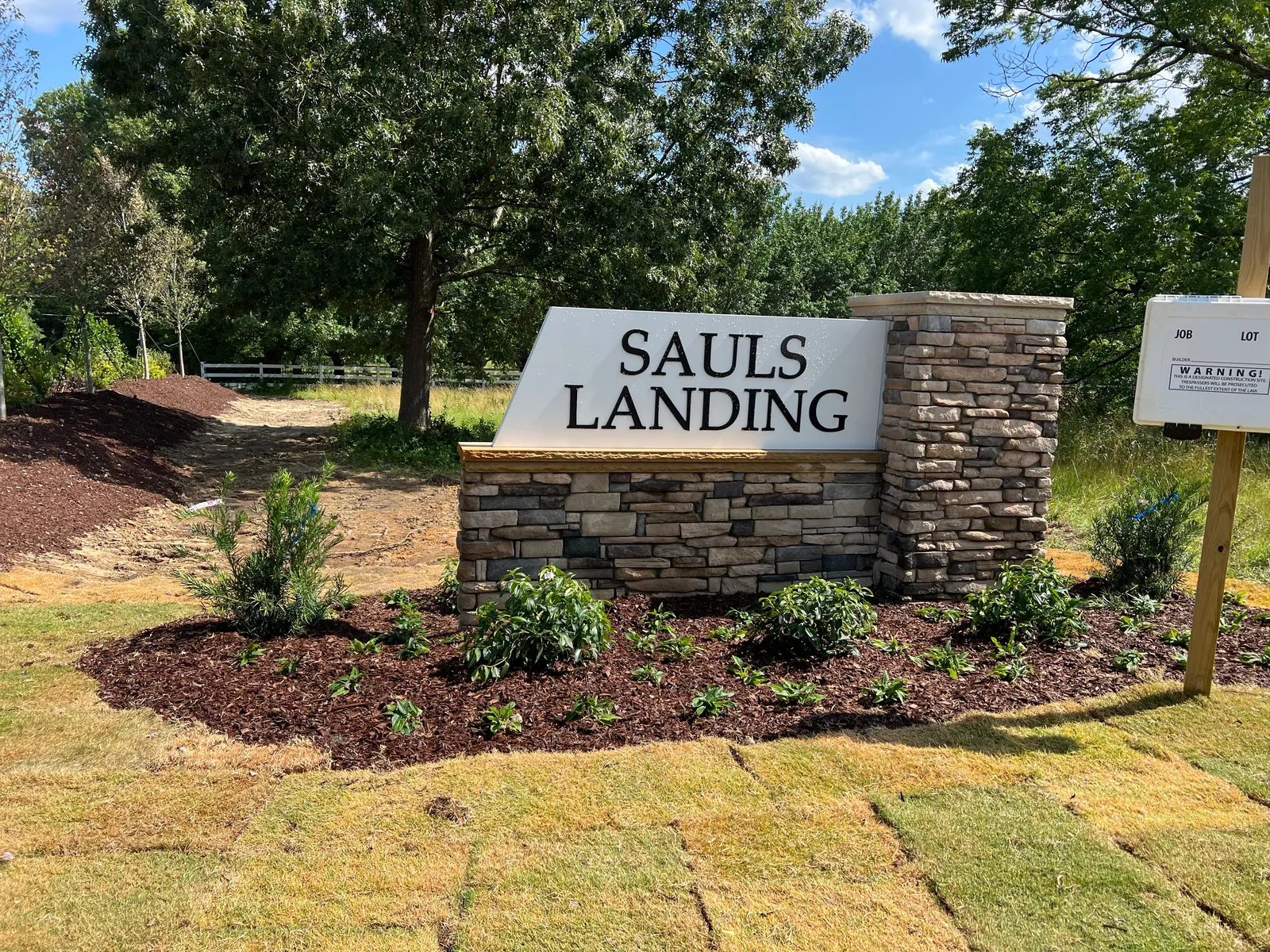 Sauls Landing entrance sign with new mulch beds and plantings