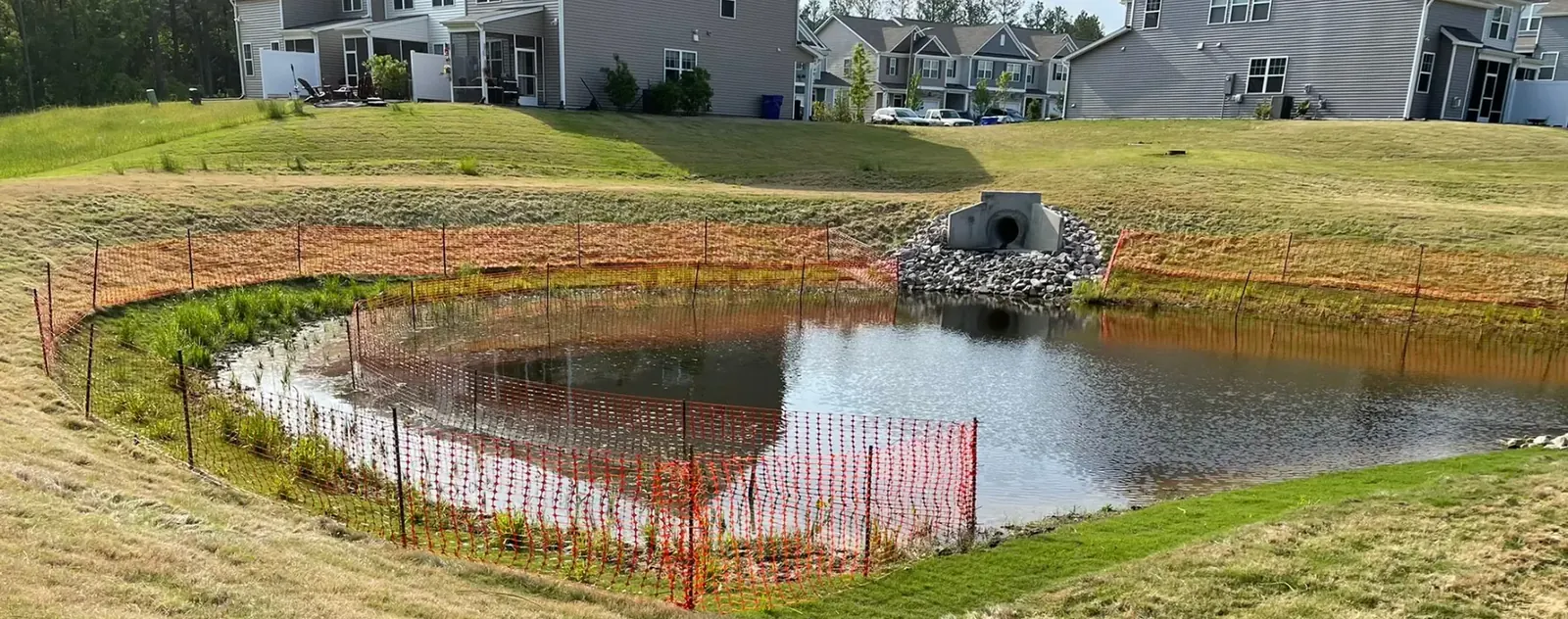 Converted stormwater retention pond with stabilized slopes in a North Carolina neighborhood